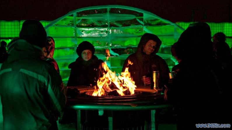 January in Montreal: People sit around a fire during Igloofest at Jacques-Cartier Pier in the Old Port of Montreal.